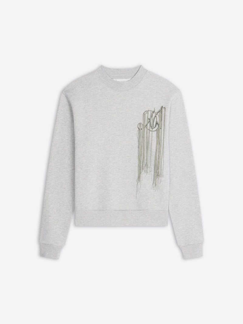 A light gray heather crewneck sweatshirt featuring a metallic embroidery on the left chest, displayed against a light gray background.