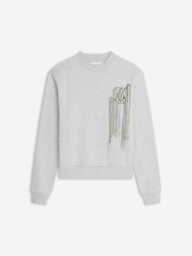 A light gray heather crewneck sweatshirt featuring a metallic embroidery on the left chest, displayed against a light gray background.
