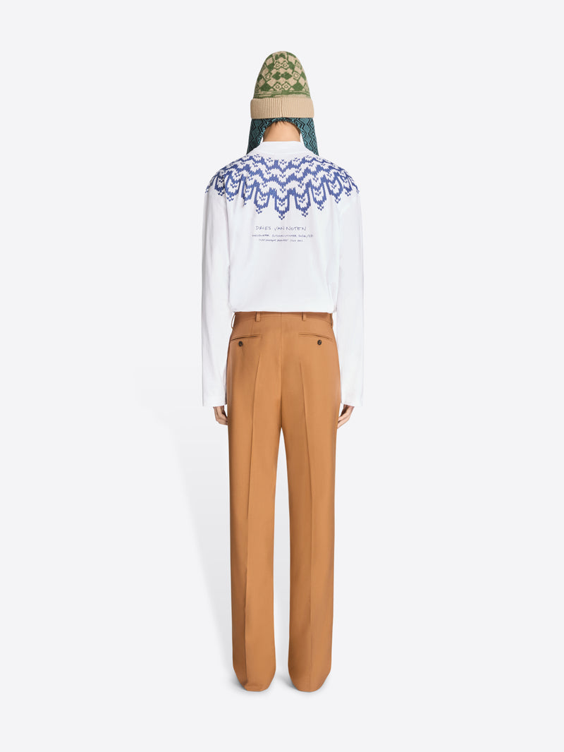 Back view of a person wearing a white long sleeve with blue pattern, light brown pants on a white background
