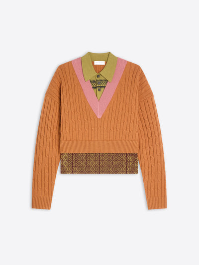 Orange sweater with patterned band and collar on a white background