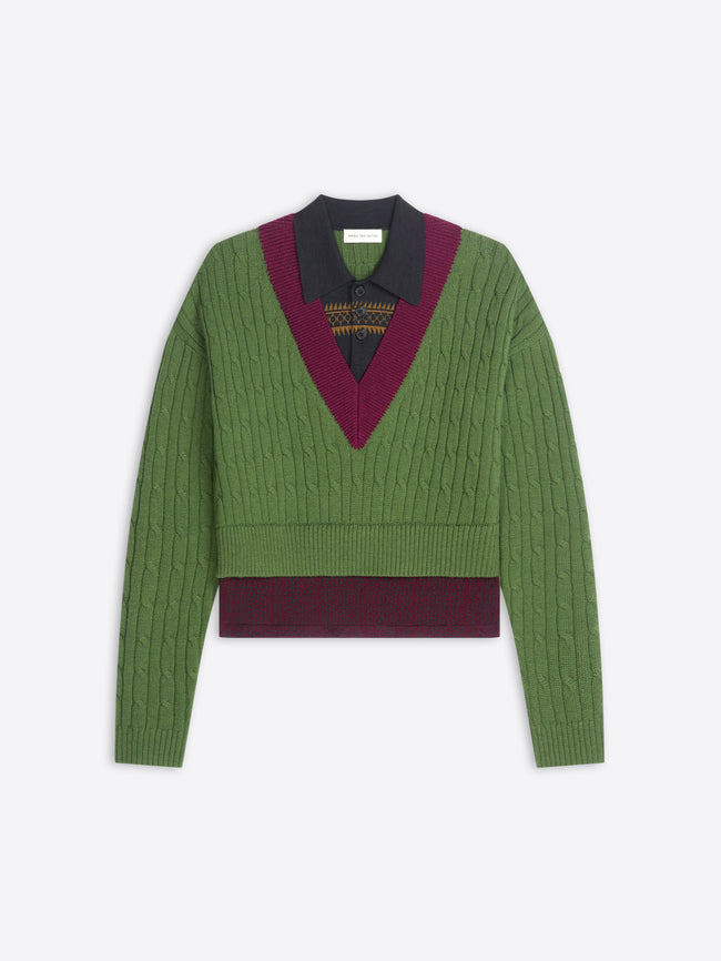 Green sweater with patterned band and collar on a white background