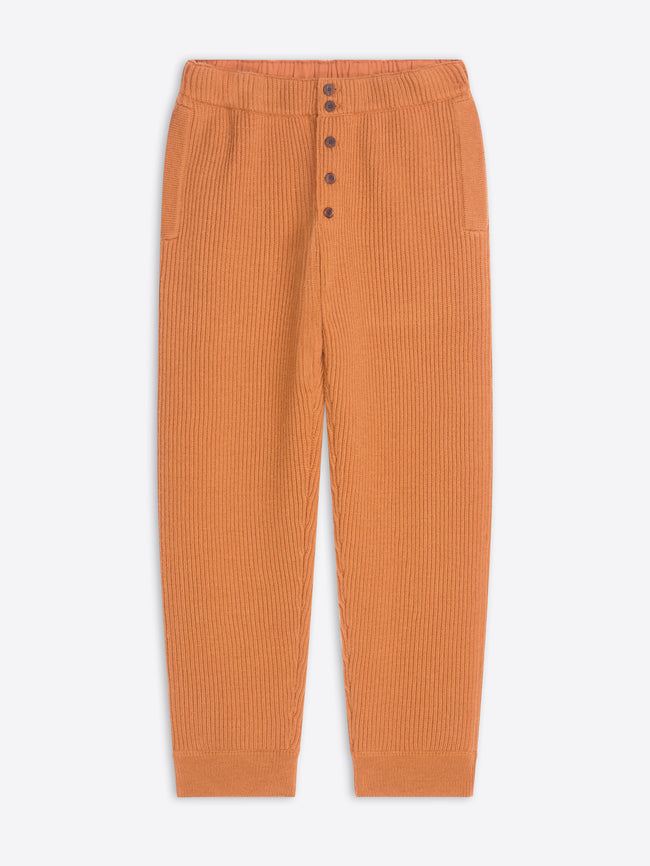 Orange ribbed pants on a white background
