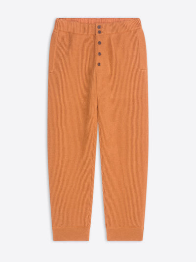 Orange ribbed pants on a white background