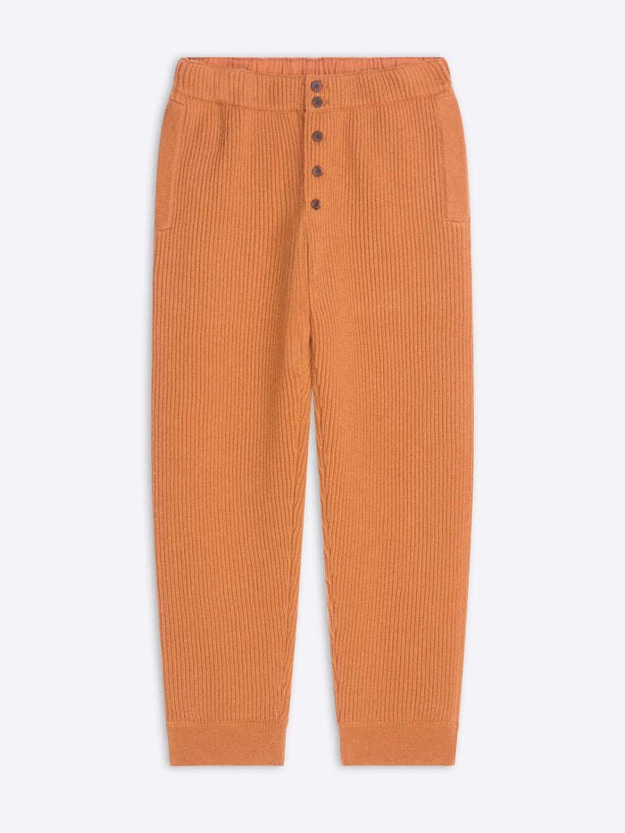 Orange ribbed pants on a white background