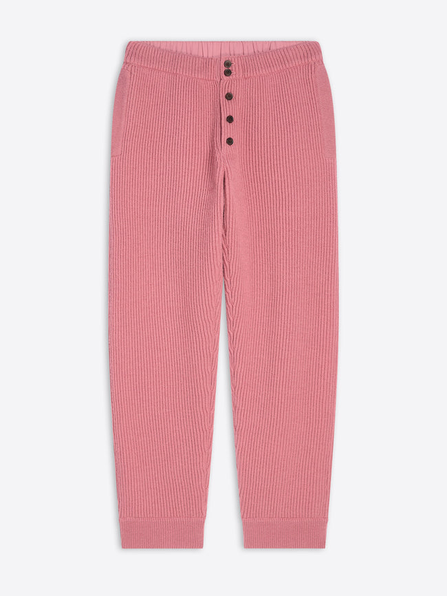 Pink ribbed pants with button details on a white background