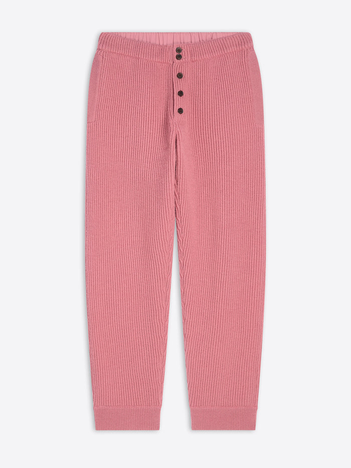 Pink ribbed pants with button details on a white background