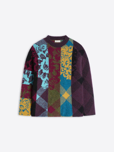 Multicolored patterned sweater on a white background