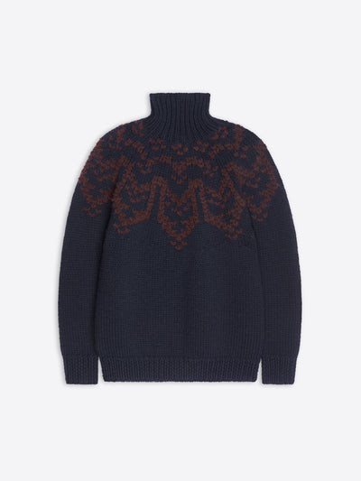 Dark blue chunky-knit turtleneck sweater with a contrasting brown jacquard motif.