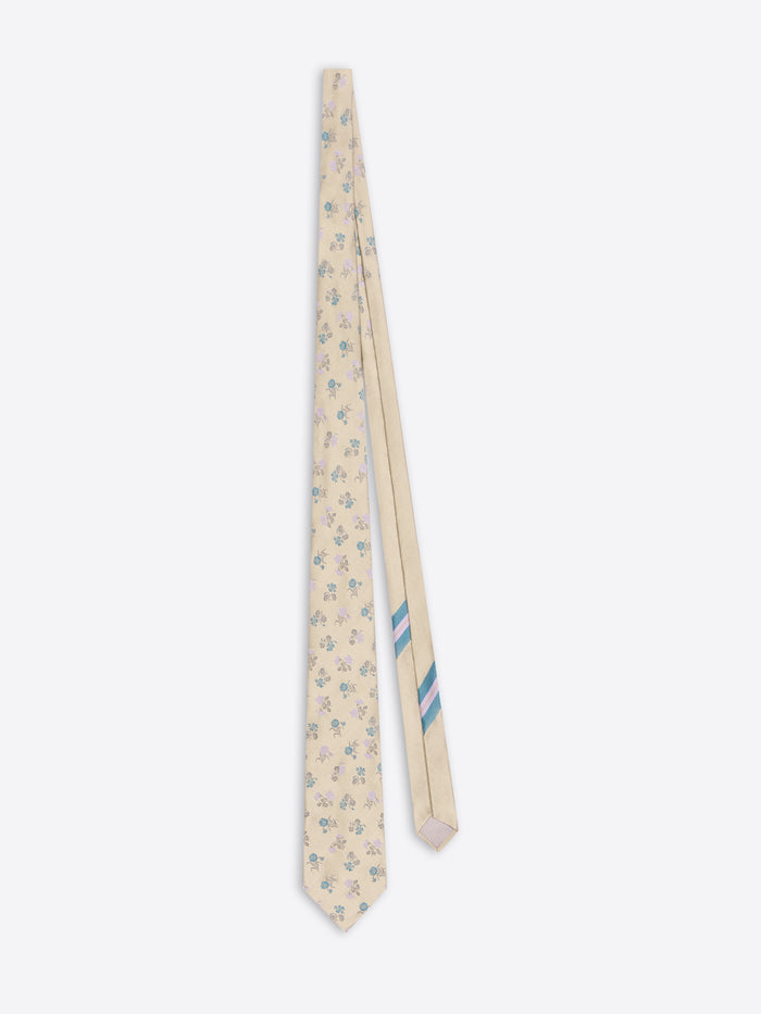 Floral-patterned tie with a blue stripe on a white background