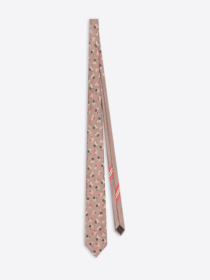 Light pink patterned tie with a subtle floral motif on a white background 