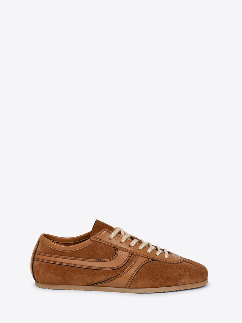 A brown suede low-top sneaker on a light gray background 