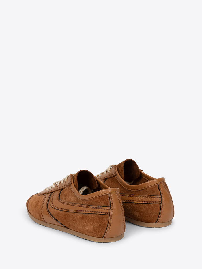 A pair of brown suede low-top sneakers against a light gray background.
