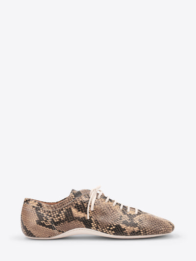 A low-top lace-up sneaker featuring a snakeskin pattern, with white laces and a white sole, shown on a light gray background.