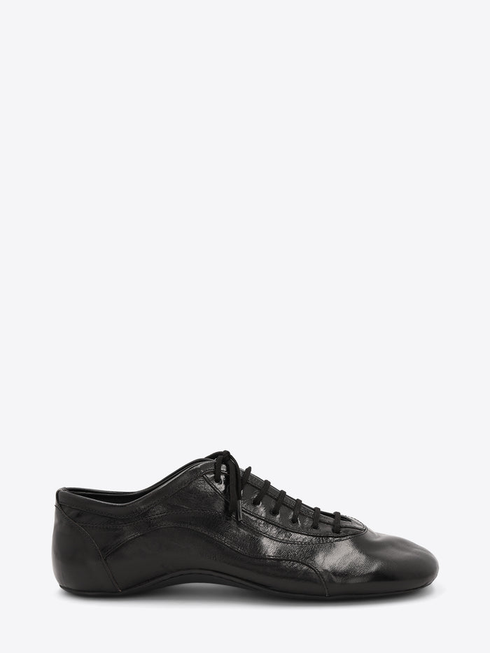 A single black leather low-top lace-up shoe with a glossy finish, displayed on a light gray background.