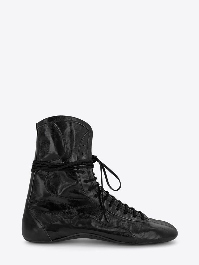 A single black leather lace-up boot with a glossy finish, shown on a light gray background.