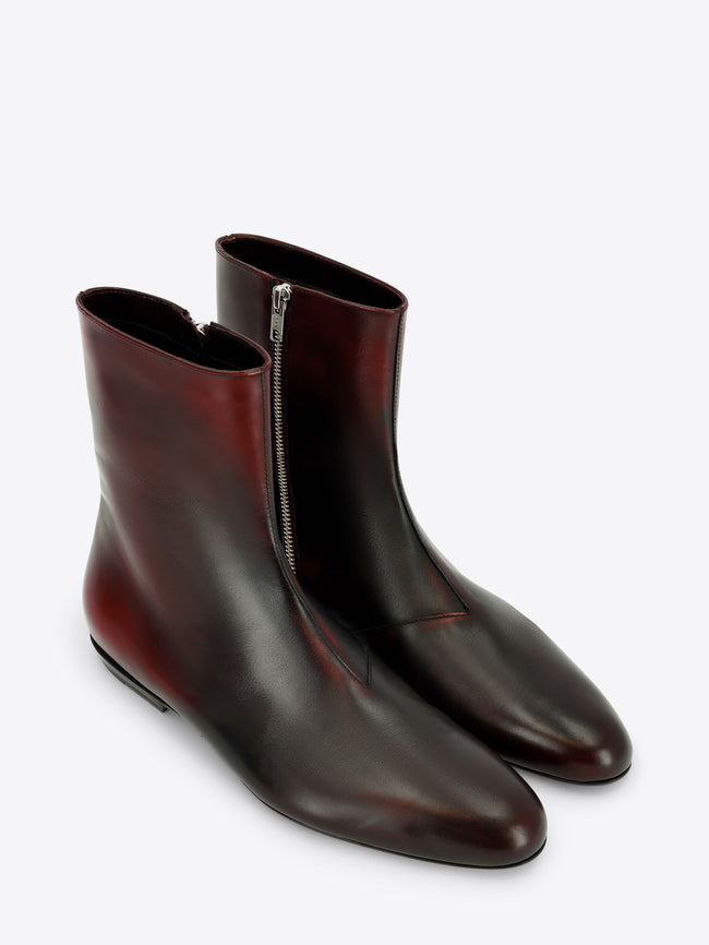 A pair of dark brown leather ankle boots with a side zipper, shown on a light gray background.