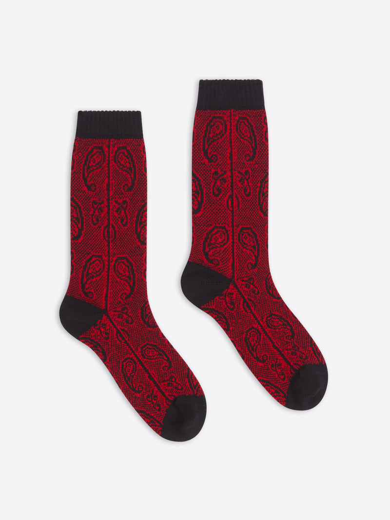Red socks with black patterns and cuffs on a white background