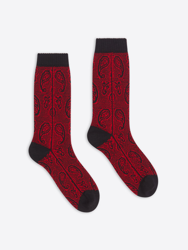 Red socks with black patterns and cuffs on a white background