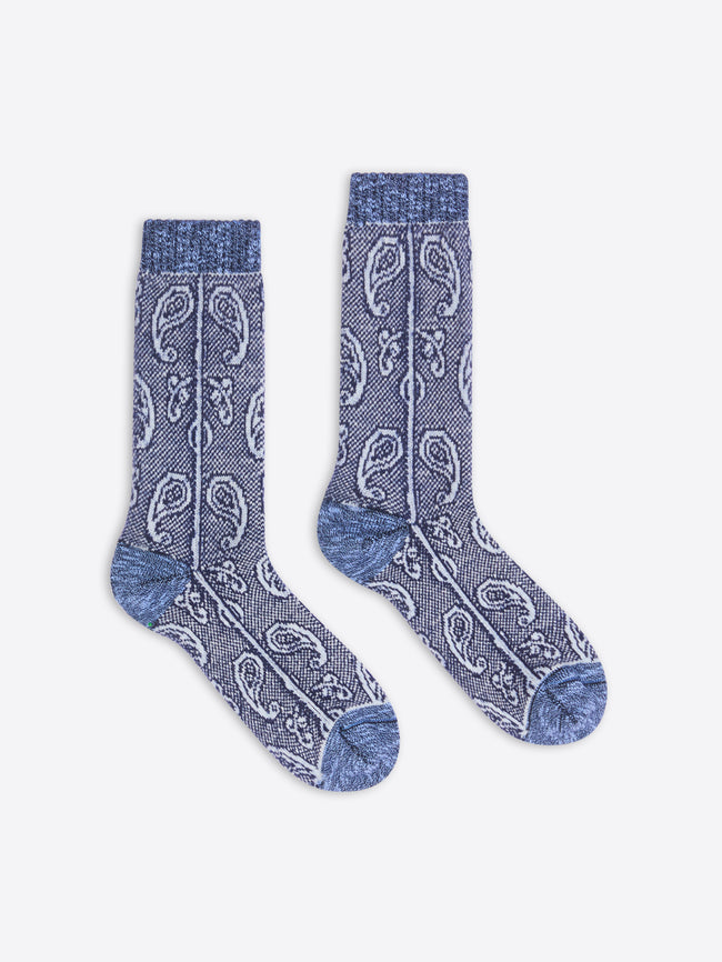 Pair of blue patterned socks on a white background