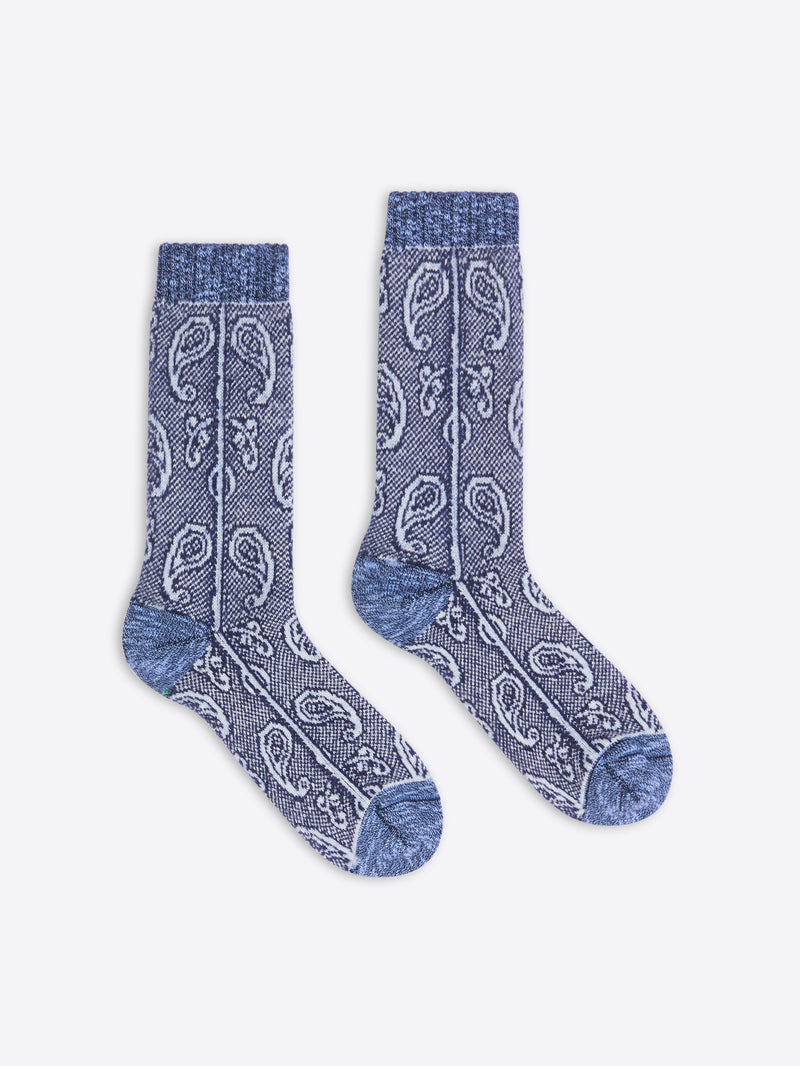Pair of blue patterned socks on a white background