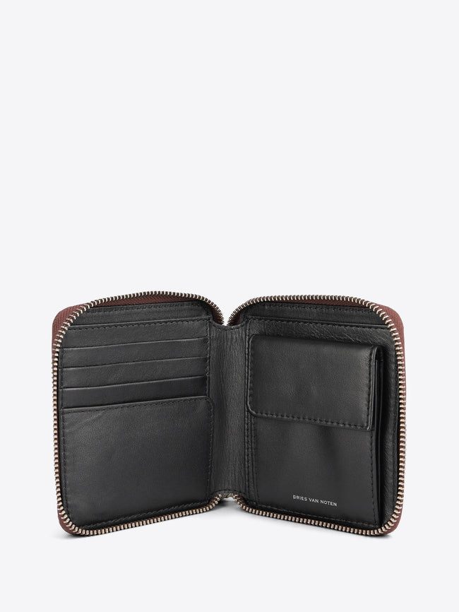 An open leather zip-around wallet with multiple card slots and a cardholder pocket, shown against a light gray background.