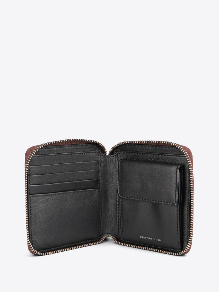 An open leather zip-around wallet with multiple card slots and a cardholder pocket, shown against a light gray background.