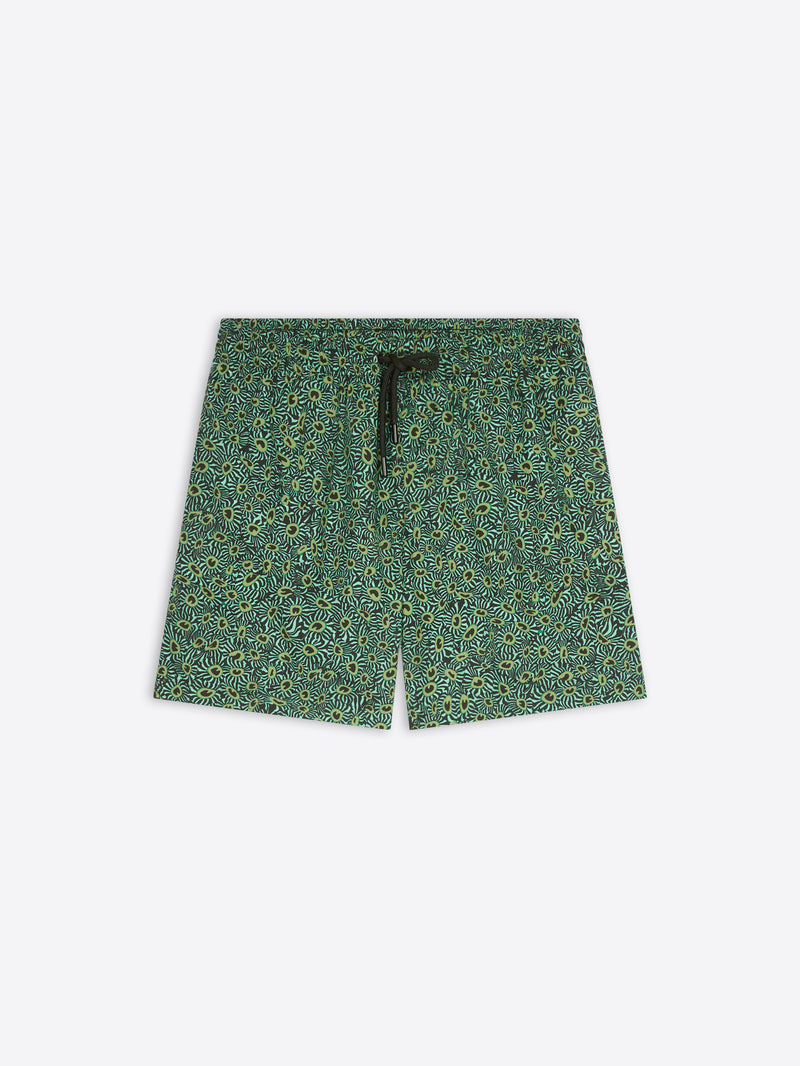 A pair of men's shorts featuring an all-over green and yellow floral pattern, with a black drawstring at the elastic waistband, shown flat on a light gray background.