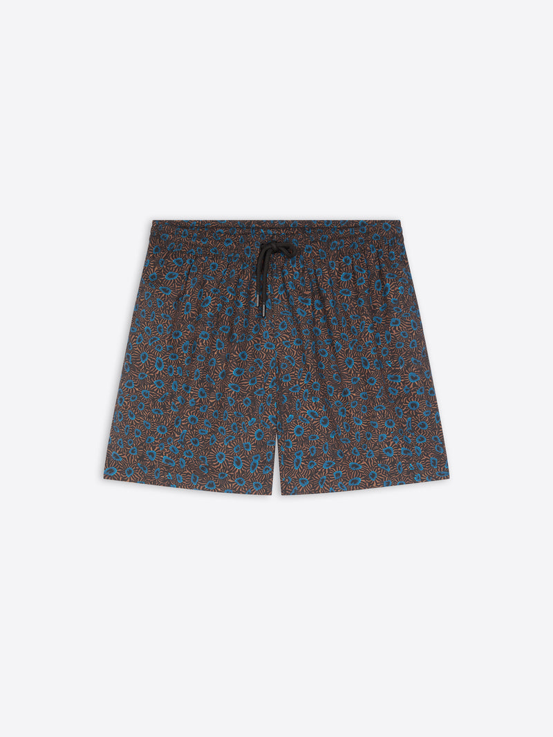 A pair of men's swim shorts featuring an all-over small-scale floral pattern in blue and brown on a dark base, with a matching dark drawstring at the elastic waistband, shown flat on a light gray background.