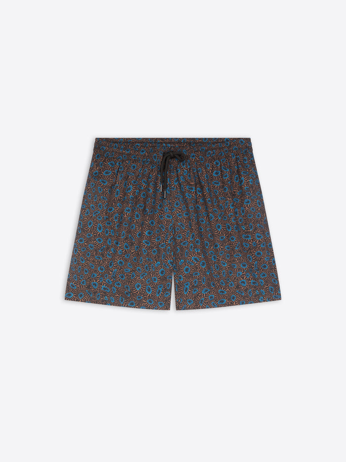 A pair of men's swim shorts featuring an all-over small-scale floral pattern in blue and brown on a dark base, with a matching dark drawstring at the elastic waistband, shown flat on a light gray background.