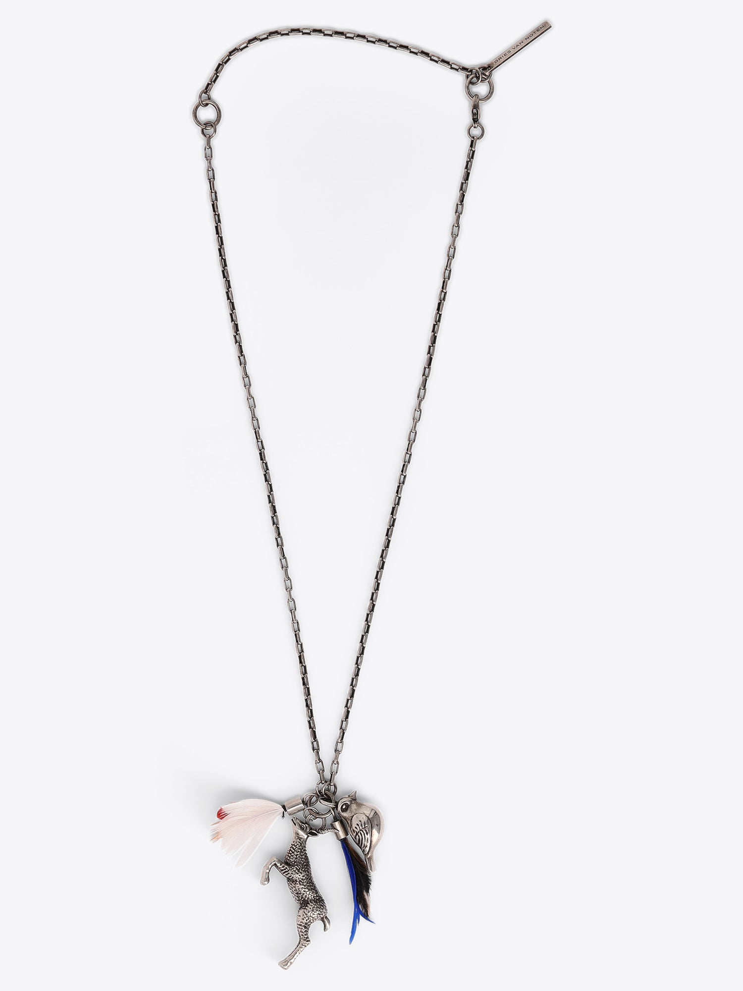 A silver-toned chain necklace with a unique pendant featuring a silver bird, and a blue feather detail, shown against a white background.