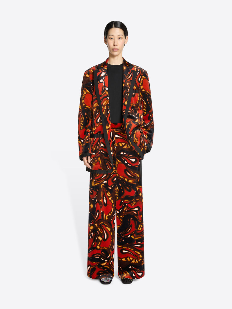 Person wearing a colorful patterned suit on a white background