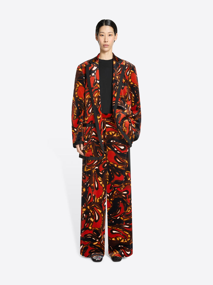 Person wearing a colorful patterned suit on a white background