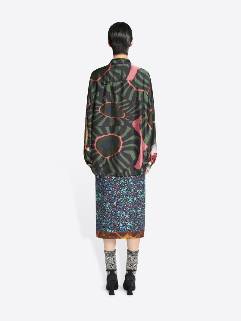Back view of a person wearing a patterned outfit on a white background