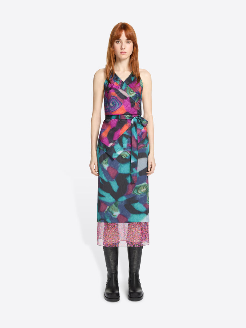 Model wearing a colorful patterned set on a white background