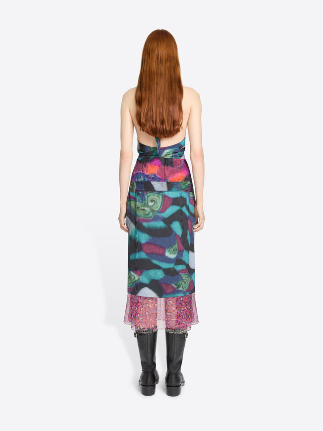 Model wearing a colorful set with a patterned hem on a white background