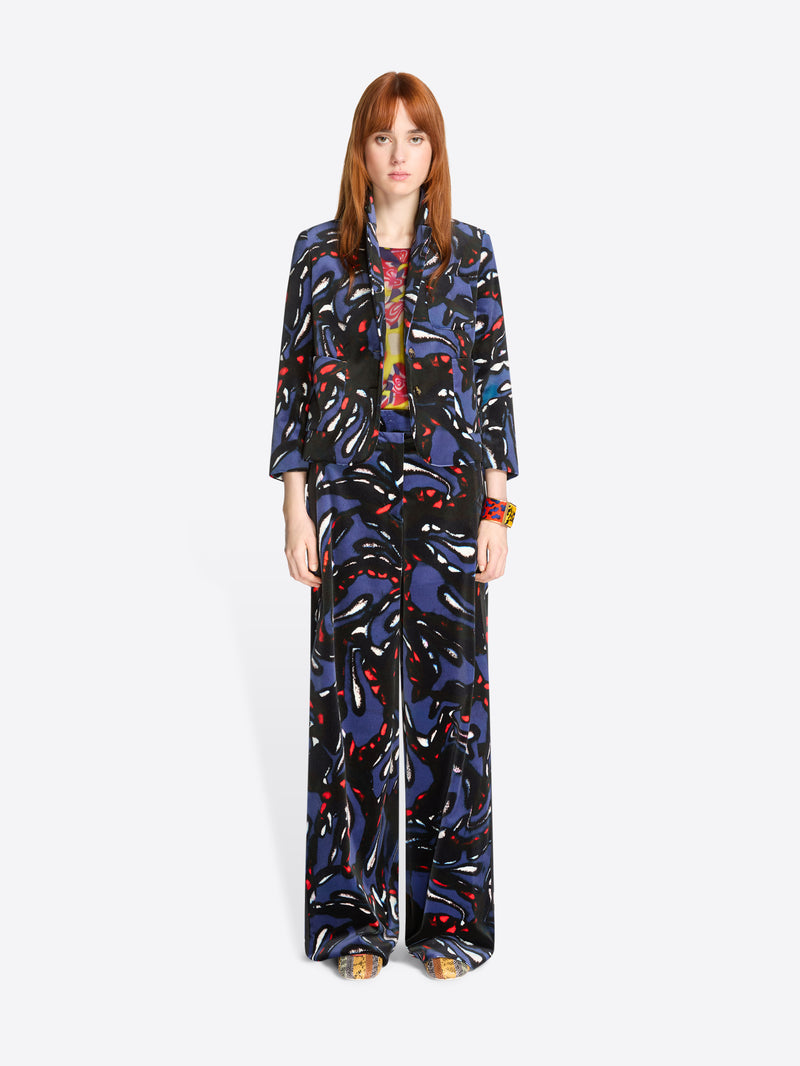 Woman wearing a colorful patterned set on a white background
