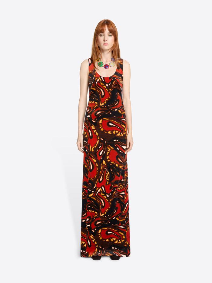 Model wearing a sleeveless dress with abstract pattern on a white background