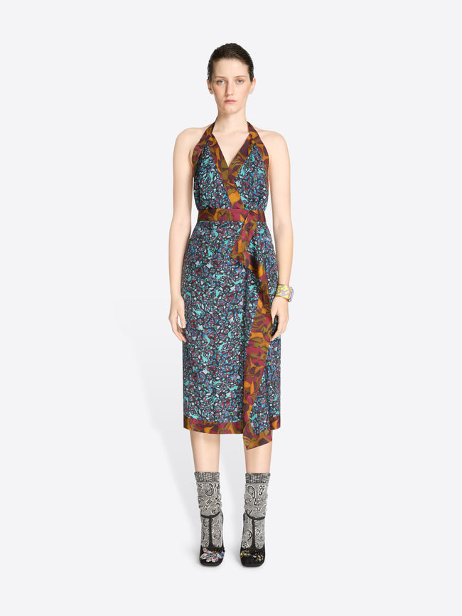 Woman wearing a patterned dress on a white background