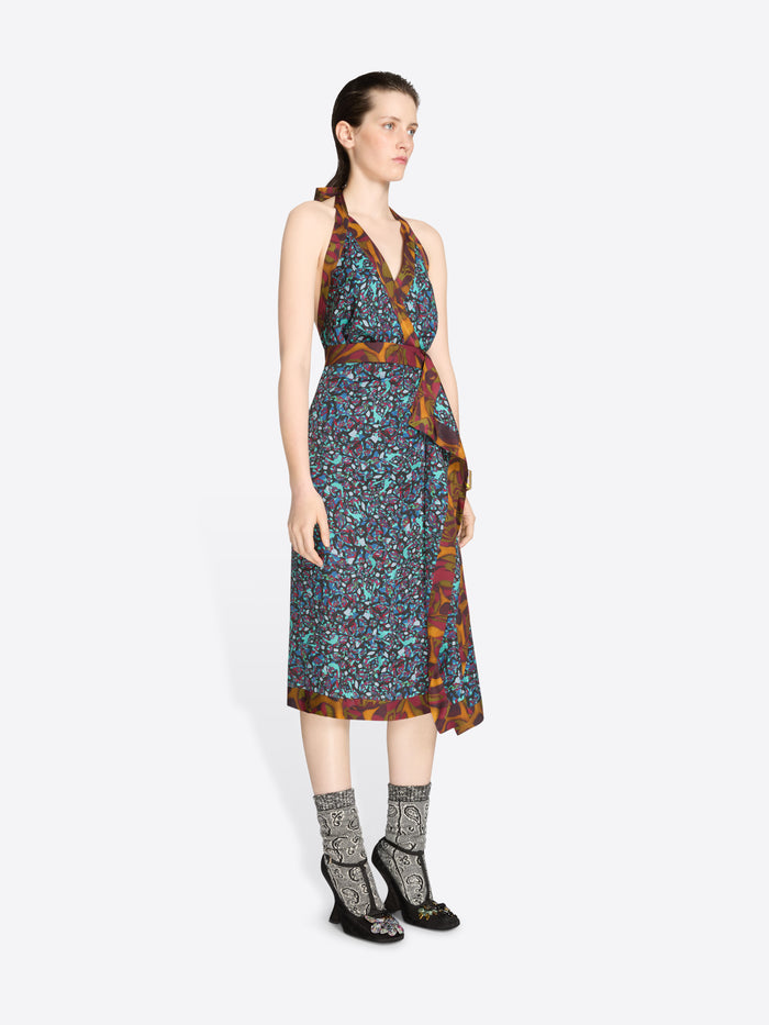 Woman wearing a patterned dress on a white background
