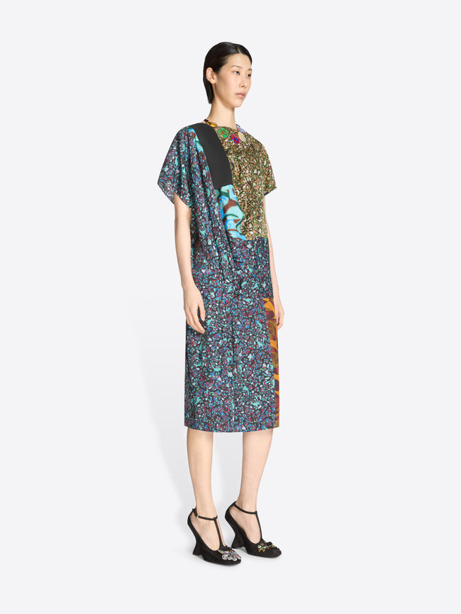 Woman wearing a patterned dress with a plain background