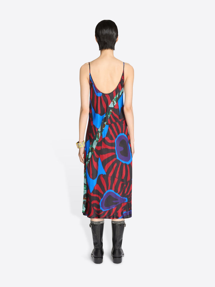 Back view of a person wearing a colorful dress on a white background