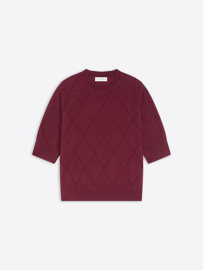 Burgundy knit top with diamond pattern on a white background