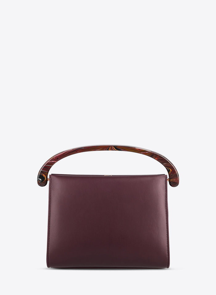 Burgundy handbag with wooden handle on a white background