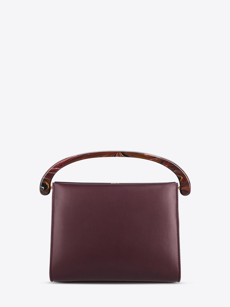 Burgundyhandbag with wooden handle on a white background