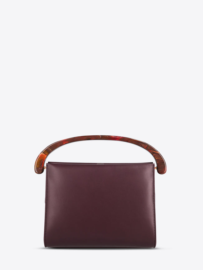 Burgundy handbag with wooden handle on a white background