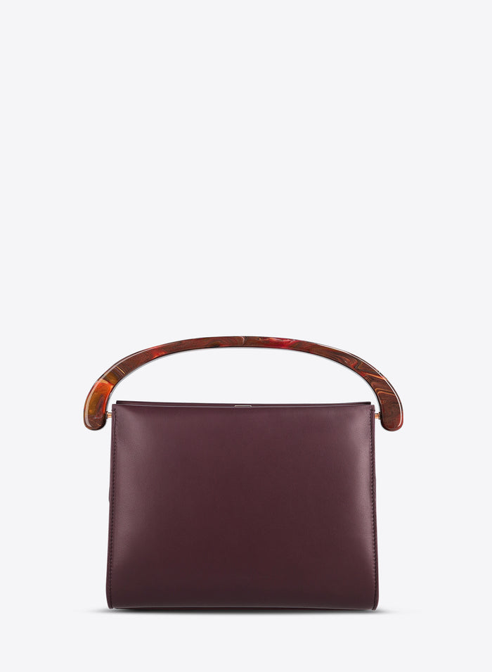Burgundy handbag with wooden handle on a white background