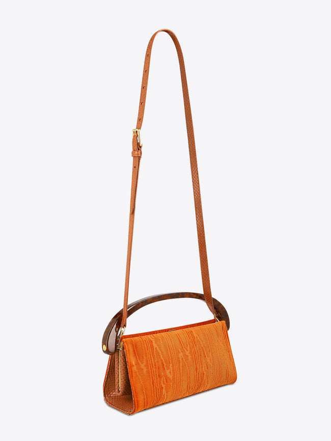 Orange handbag with a strap on a white background