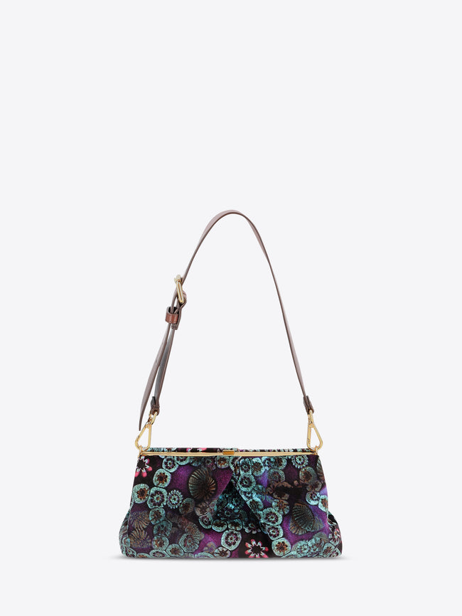 Floral patterned handbag with a strap on a white background