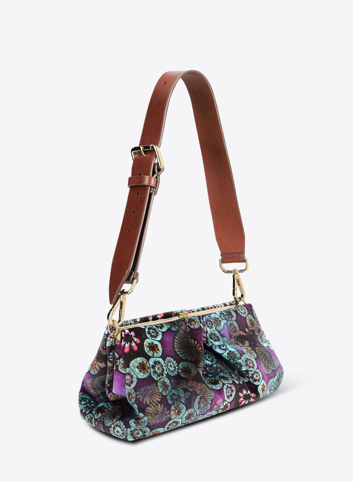 Multicolored patterned handbag with a brown strap on a white background