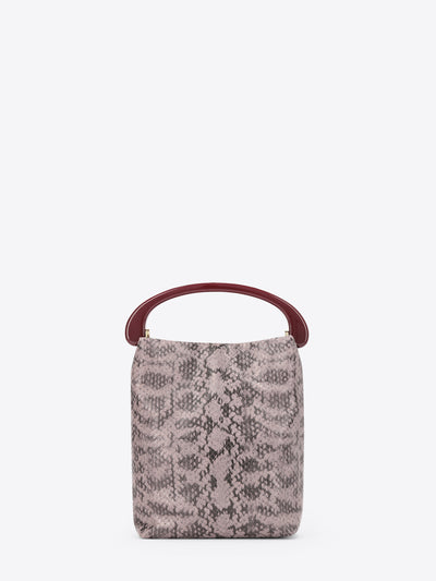 Small handbag with snake print and burgundy handle on a white background